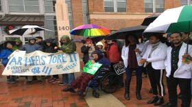 Demonstrators gather outside the UNC Board of Governors' December meeting to protest the Board's settlement that gives the Sons of Confederate Veterans $2.5 million.