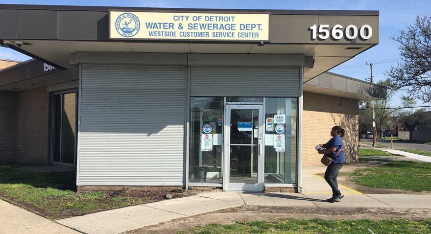 A customer walks into a Detroit Water Department customer service center