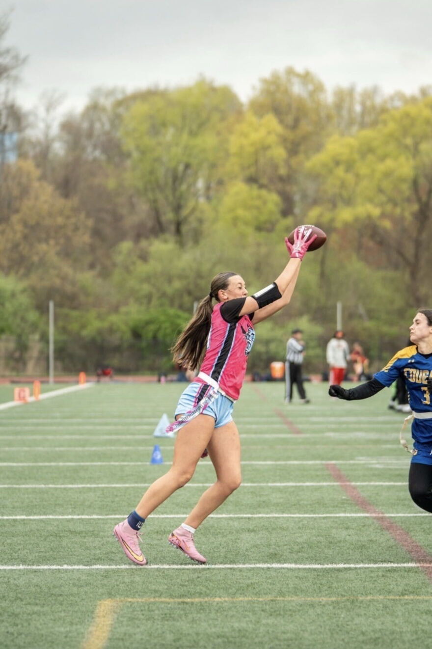 Bella Nunes catches a pass during a flag football game.