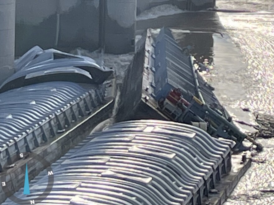 Three barges have become jammed up against the McAlpine Dam on the Ohio River, just off the shore in Louisville, Ky. Officials say a barge carrying 1,400 tons of methanol is partially submerged.