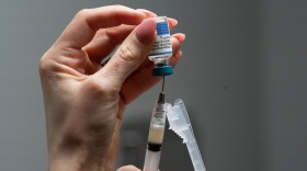 FILE - Lauren Ellenburg, a nurse, prepares a combination measles, mumps and rubella vaccine for a patient at Tiger Pediatrics in Easley, S.C., March 17, 2026.