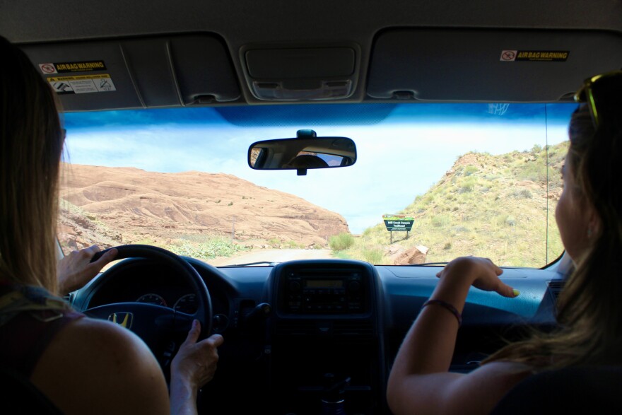 Corticelli (left) and Drozdetski (right) discuss some of their favorite places to recreate in their town of Moab as they head up to the Mill Creek Canyon Trailhead to get the temperature.