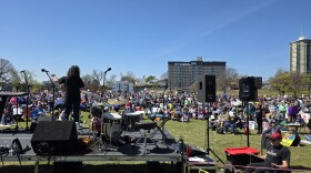 Stacey Woolley (on stage), a member of the Tulsa Public Schools board, addresses a crowd at Dream Keepers Park as part of Tulsa's third "No Kings" protest on March 28, 2026.