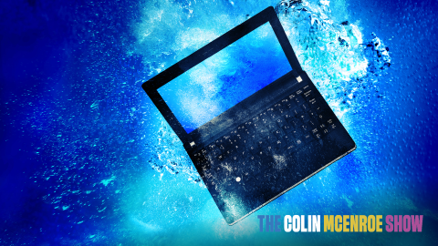 Computer netbook sinking underwater.
