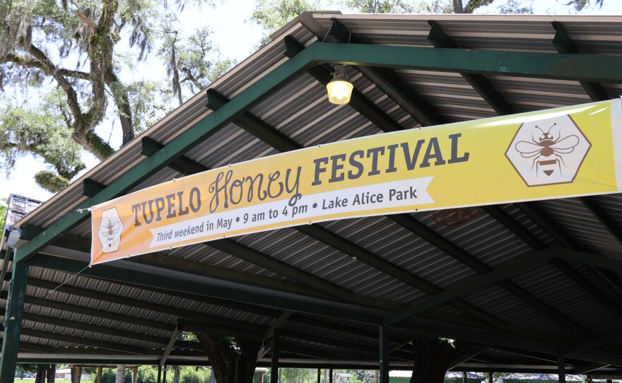 Banner for Tupelo Honey festival sits along the entrance to the atrium for the Tupelo festival.
