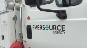 A white truck has the Eversource logo on the door.