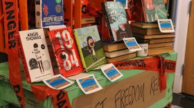  Banned book section at Midtown Reader with books like 'Heartstopper' by Alice Oseman and 'Lord of the Flies' by William Golding.