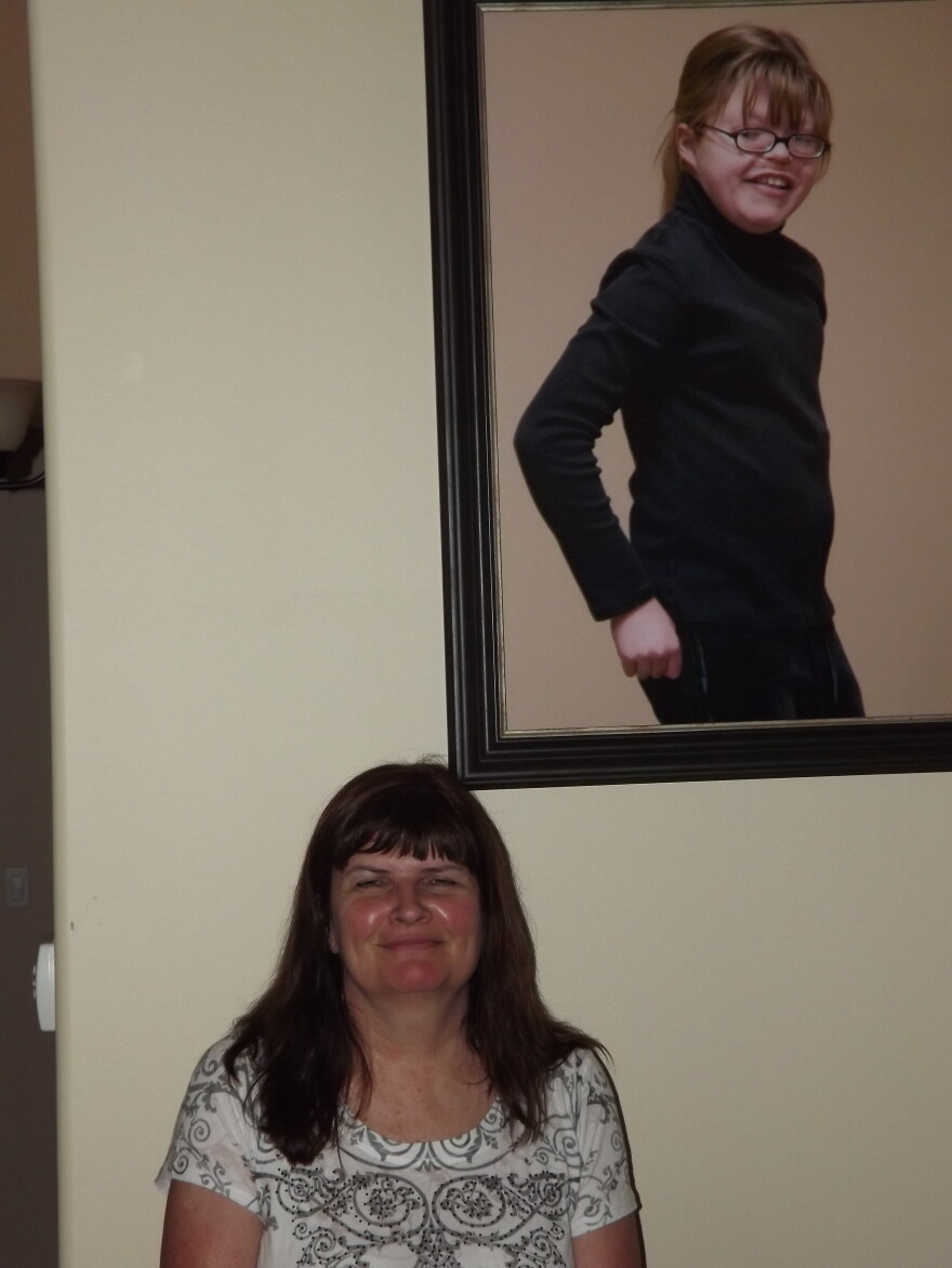 Bobbi Mathews with a photo of her daughter Katie
