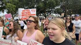 Haile Raybuck, left, and her sister, Karlie Hardick, attend the "We Won't Go Back" rally Friday in St. Petersburg, where several hundred people marched to protest the U.S. Supreme Court decision that overturned Roe v. Wade. (Octavio Jones/ WUSF Public Media)