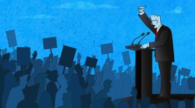 Politician speaking to a large crowd of people.