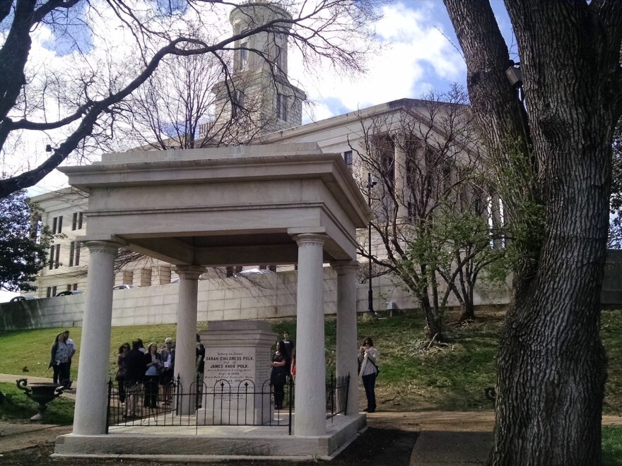 A tour group visits the tomb of President James K. Polk and his wife Sarah Childress Polk on the grounds of the Tennessee State Capitol.