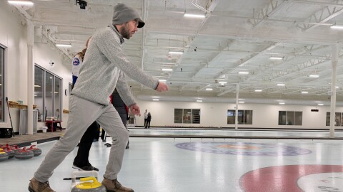 Austin Rowlader out on the sheet. Notice the 'orange-peel' sheen on the ice. (Vivian La, IPR News)