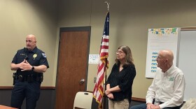 Davenport Police Maj. Greg Behning (interim police chief) speaks at a May 18 community meeting at the Davenport Library's Fairmount branch on ICE actions, as Allison Ambrose and Ken Croken look on.