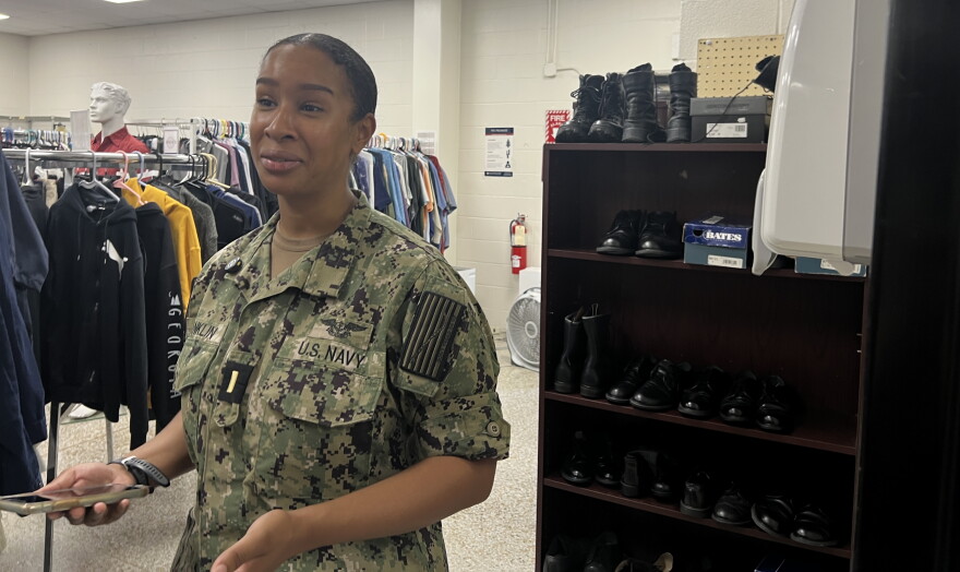 Active-duty Navy sailor Victoria Franklin looks through clothing at the Navy-Marine Corps Relief Society thrift shop on NAS Pensacola. Franklin saod she first visited the shop as a young sailor and found the lower prices helped ease the financial pressure of buying military clothing.