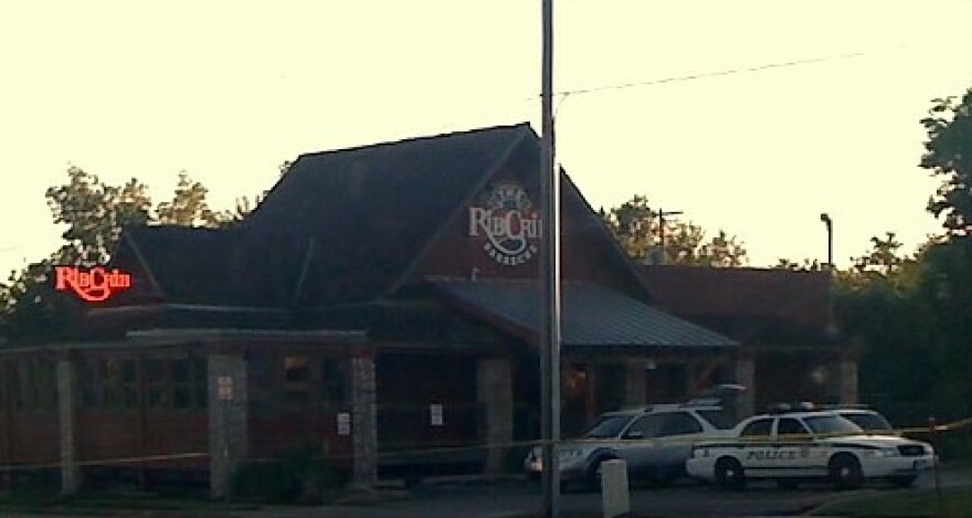 Yellow crime scene tape surrounds the 16th and Harvard Rib Crib at daybreak on Friday.