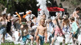 Kids play in bubbles at at the Park City Day Camp.