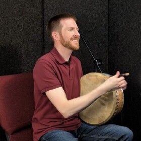 Percussion instructor and co-director of the Kentucky Irish Music Academy, Jeremy Wade, plays the frame drum called the bodhran.