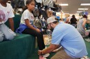 Immokalee children get new shoes through the Laces of Love program. Staff members at Snyderman's Shoes in Naples recently fitted the kids with footwear.