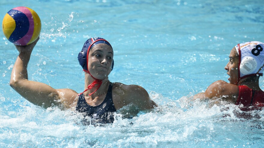American Maggie Steffens pump-fakes as Spain's María del Pilar Peña Carrasco looks on, during their preliminary round game on Tuesday. Not to worry, novices: "Pump fake" is in the glossary.