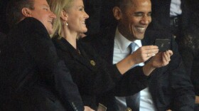 President Obama and British Prime Minister David Cameron pose for a "selfie" with Danish Prime Minister Helle Thorning Schmidt during the memorial service for Nelson Mandela.