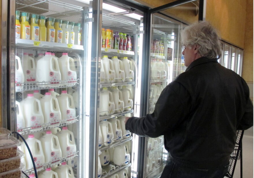 A man shops for milk in a grocery store
