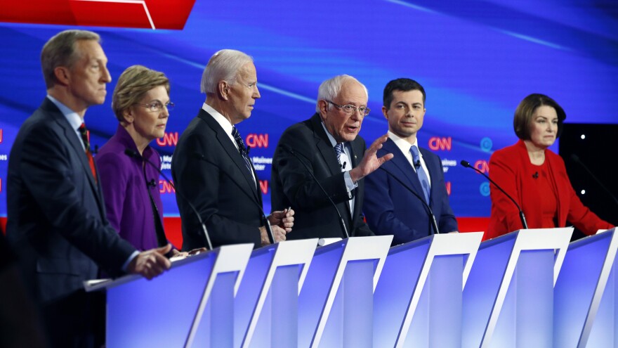 Democratic presidential candidate Sen. Bernie Sanders (center) speaks as fellow candidates businessman Tom Steyer (from left), Sen. Elizabeth Warren, former Vice President Joe Biden, former South Bend Mayor Pete Buttigieg and Sen. Amy Klobuchar, listen on Jan. 14, during a Democratic presidential debate. Andrew Yang will also be on stage Friday.