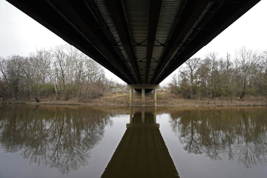 The Tar River flows under the bridge connecting Tarboro and Princeville, N.C., Thursday, March 10, 2022. The river has flooded twice in recent history due to hurricanes, leaving permanent scars on the town of Princeville.