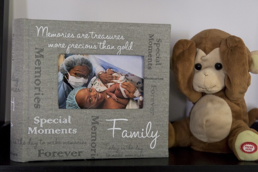 A photograph of Shalon with newborn daughter Soleil and mother Wanda is displayed on a shelf in Shalon's home next to the stuffed monkey that was given to Soleil in the hospital after she was born.