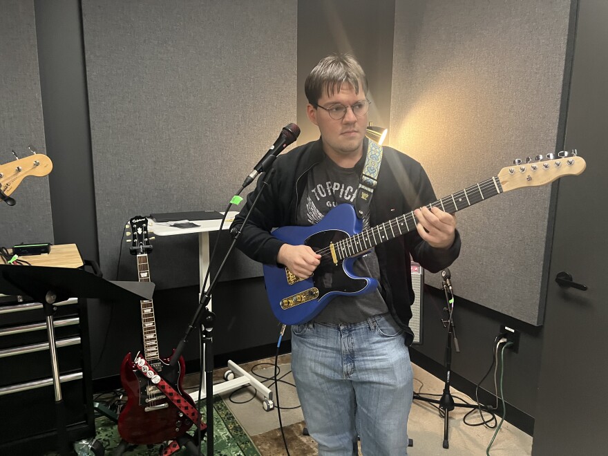 Instructor Jacob Mick on guitar.