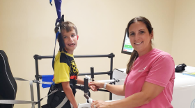 Pediatric therapist Sarah Prebich helps her patient Liam in the Rise&Walk.