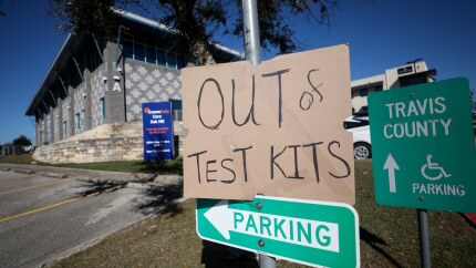 A sign at Travis County Community Center at Oak Hill notifies walk-ups that the location was out of at-home COVID-19 test kits on Dec. 22, 2021.
