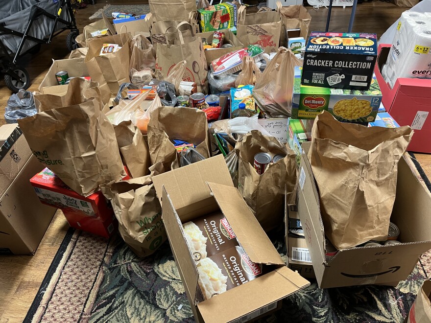 Floor covered with donated groceries from community food drive.
