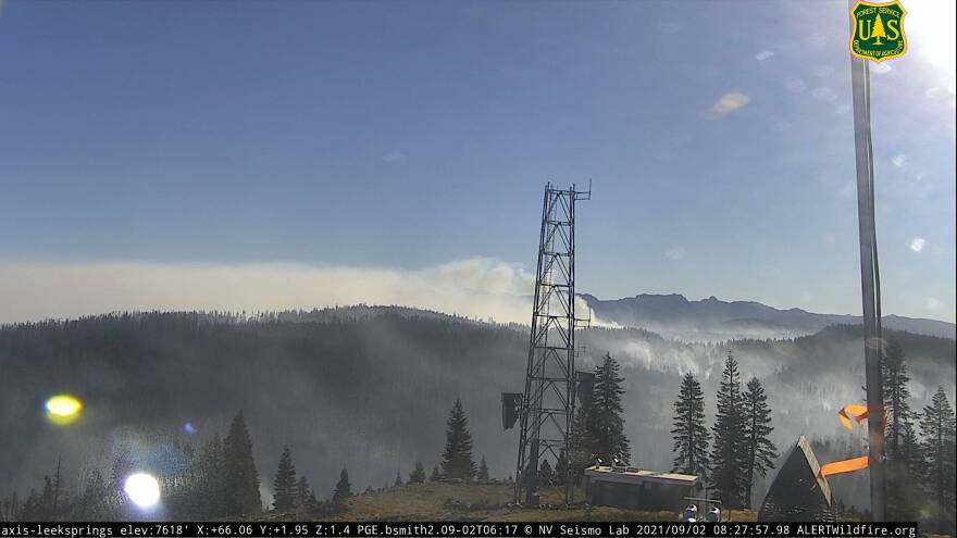 Mountains with smoke emerging from them.