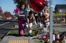 Children place flowers at a makeshift memorial outside Silver Rail Elementary in Bend, Oregon, Friday, Oct. 16, 2026, a day after a deadly shooting. (Joe Kline/AP)