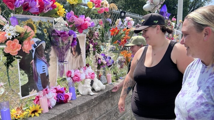 Chantel Smith, right, smiles at a photo of her daughter Lexi Thornton. Former neighbors Simone Aune and her son Landon Gorton were reminiscing July 17, 2026, outside Smith's Brainerd home. A memorial continues to grow in honor of 13-year-old Lexi, who died by suicide on July 10.
