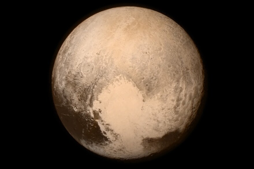 An image of Pluto that was taken by New Horizons shortly before its flyby Tuesday shows a heart-shaped pattern on the planet's surface. NASA says Pluto "sent a love note back to Earth."