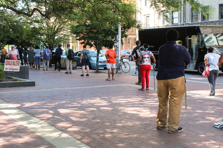 Voters try to maintain social distance as they wait in line at the Indianapolis City-County building on primary election day.