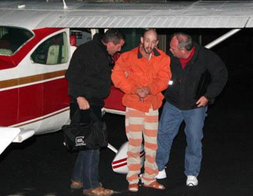 Police bring Taylor into custody on Sunday.