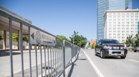 A motorist drives by a police barricade placed along Sheridan Avenue in downtown Oklahoma City in advance of a visit from President Barack Obama Wednesday.