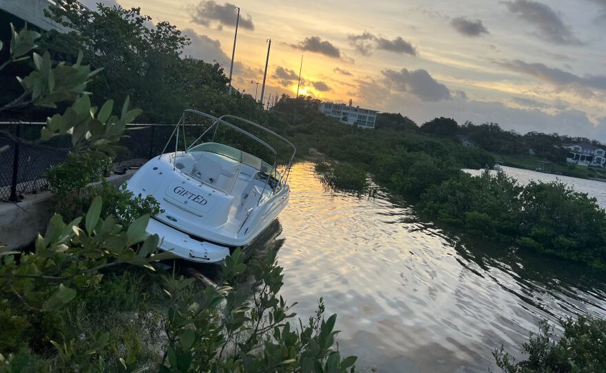 A boat lies along the Belleair Causeway following Hurricane Helene on Sept. 27, 2024.