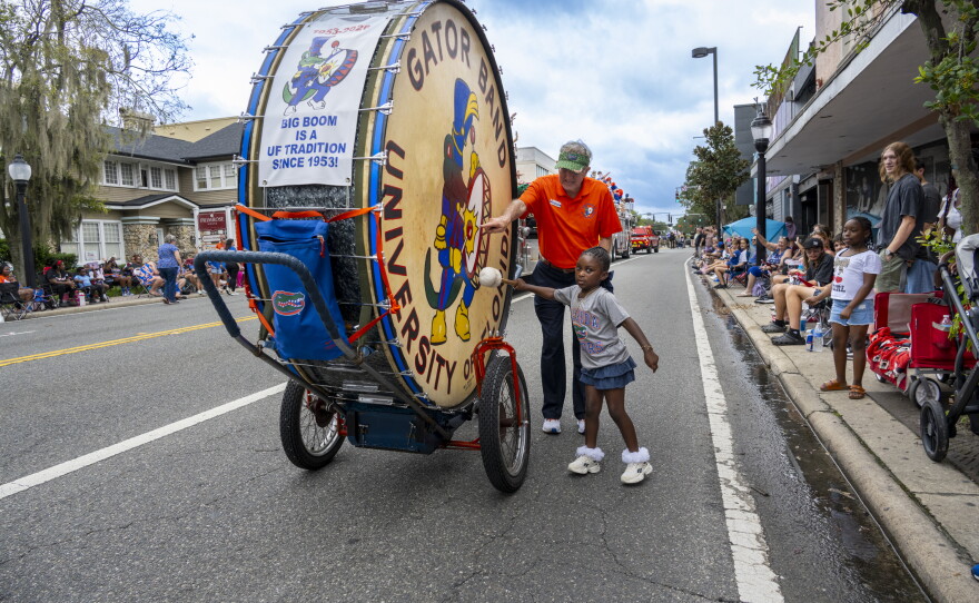 A child plays the Big Boom with the Gator Band during the University of Florida Homecoming parade Oct. 9, 2026, in Gainesville, Fla. (Andy Acosta/WUFT News)