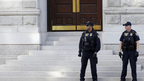 Officers with the Department of Homeland Security patrol outside the federal courthouse in Charleston, S.C., on Nov. 7.