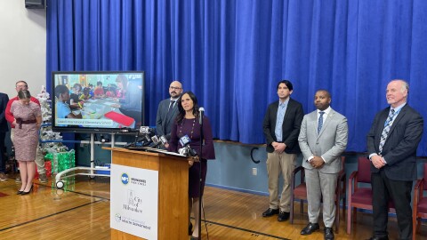 Michael Turza (far right) accompanies Milwaukee Public Schools Superintendent Brenda Cassellius and Milwaukee Mayor Cavalier Johnson (left of Turza) at a news conference regarding the school district's lead paint remediation project on Dec. 17, 2025.