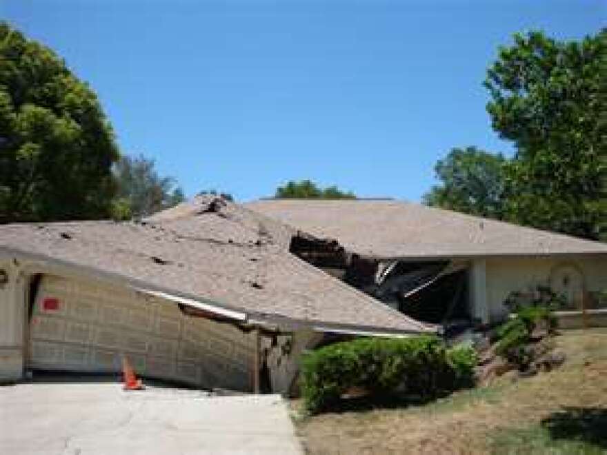 A house being swallowed by a sinkhole