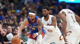 Denver Nuggets guard Bruce Brown, left, collects a loose ball as Cleveland Cavaliers guards Donovan Mitchell, center, and James Harden defend in the second half of an NBA basketball game, Monday, Feb. 9, 2026, in Denver. 