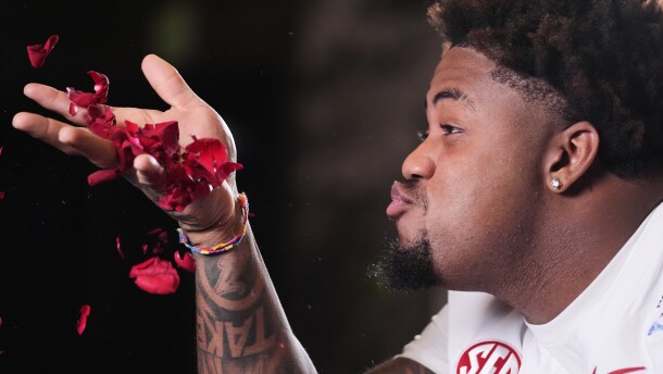 Alabama defensive lineman James Smith (23) blows rose pedals during a video shoot ahead of Thursday's Rose Bowl College Football Playoff against Indiana Tuesday, Dec. 30, 2025, in Los Angeles. (AP Photo/Marcio Jose Sanchez)