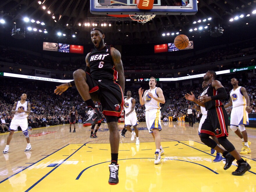 LeBron James reacts after dunking the ball as his Miami Heat played the Golden State Warriors on Jan. 10, 2012, in Oakland, California.