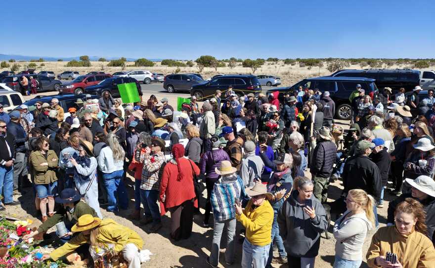 Part of the crowd on Sunday stands near the makeshift memorial. The crowd sang along to "House of the Epstein Crimes"