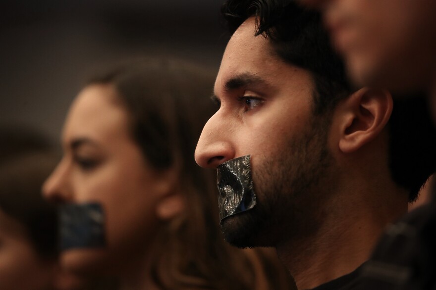 Georgetown University Law School students cover their mouths with tape to protest Sessions' speech on Tuesday.