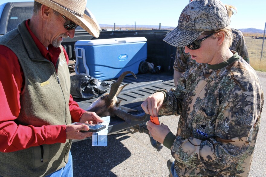 WGFD Wildlife Biologist Dean Clause checks hunters licenses at a check station in Sublette County.